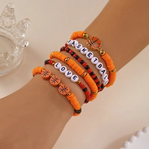 Close-up of orange heishi beads basketball theme multi-layer bracelet set with charms
