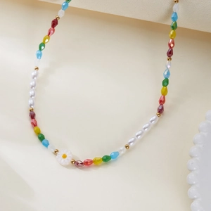 Detail of colorful faceted beads with imitation pearls and small daisy pendant necklace