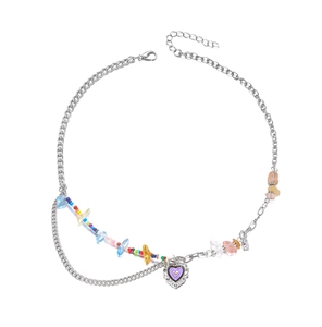 Detail of bohemian silver chain with rainbow beads and purple heart-shaped pendant charm