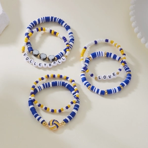 Close-up of multilayered volleyball theme beaded bracelets with clay discs and charms