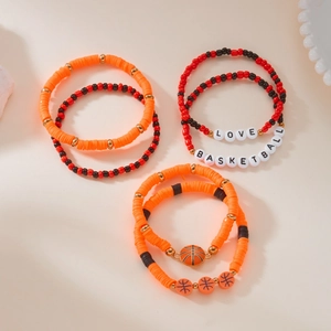 Detail view of stacked basketball-themed beaded bracelets with orange and red clay discs