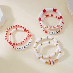 Detailed macro view of three baseball theme bracelets featuring clay beads and letter charms