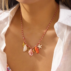 Close-up of woven rope necklace with colorful seashell, starfish and fish charms