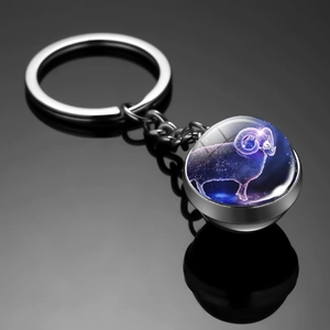 Detail of Aries constellation glass ball keychain with 3D interior engraving and reflection