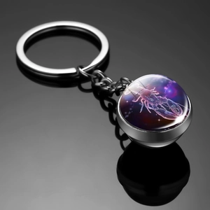 Detailed view of luminous double-sided glass ball keychain with Cancer zodiac sign