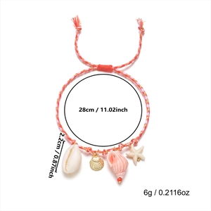 Detail of woven beach bracelet with shell and starfish pendants and red adjustable knot