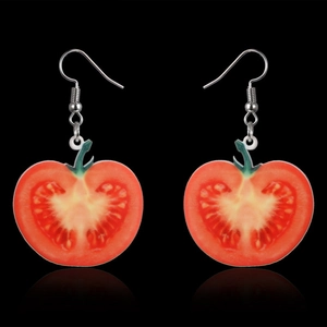 Detail of red tomato slice acrylic drop earrings with silver metal ear hooks