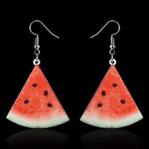 Detailed view of handmade watermelon slice earrings with red resin and silver hooks