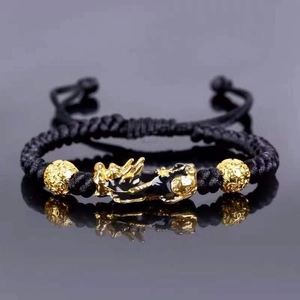 Handcrafted black rope bracelet with golden Pixiu charm and hollow beads for good luck