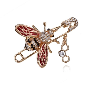 Broche abeille dorée avec ailes en émail rouge et pendentif alvéolé scintillant