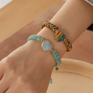 Handmade woven bracelets with heart-shaped stone pendants and colorful beads