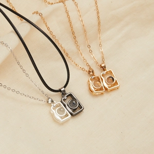 Macro detail of magnetic sun and moon couple necklaces with projection stone in four colors