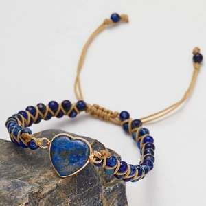 Macro view of handmade bohemian bracelet with blue heart stone and adjustable cord