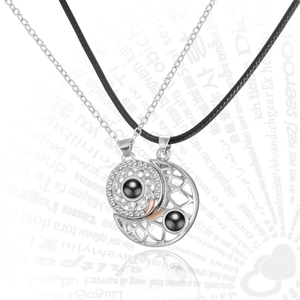 Detail of sun and moon couple necklaces with 100 languages I love you projection stone
