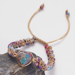 Detailed macro view of heart-shaped natural stone and colorful handmade braided beads