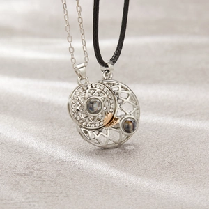 Macro detail of sun and moon magnetic pendant necklaces for couples with projection stone
