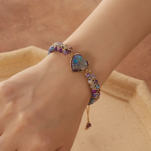 Handmade bohemian heart stone bracelet with natural beads worn on a model's wrist