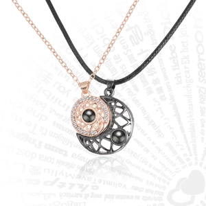 Detail of sun and moon couple necklaces with 100 languages I love you projection stone