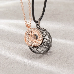 Macro detail of magnetic sun and moon couple necklaces with 100 languages projection stone