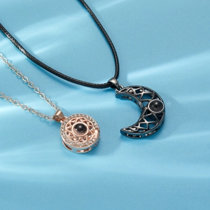 Detail of sun and moon couple necklaces with 100 languages I love you projection stone