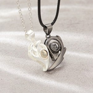 Detail of magnetic heart pendants for couples featuring a sun and moon projection stone