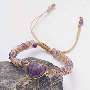 Detail of handmade woven bracelet with purple heart stone and adjustable cord