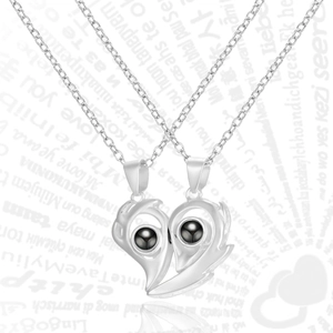 Macro detail of magnetic sun and moon couple necklaces with 100 languages projection