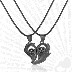 Detail of magnetic couples necklace with black half-heart pendants and projection stones