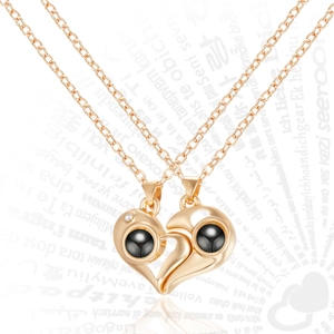 Detail of rose gold magnetic couple necklaces with heart pendants and projection stone
