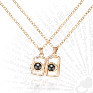 Detail of rose gold camera pendant necklaces with black projection stone and zircon inlay