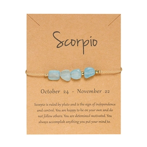 Dettaglio del braccialetto zodiaco Scorpione con pietre naturali azzurre su carta kraft