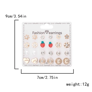 Detailed view of 12-pair earring set on display card with floral and heart motifs