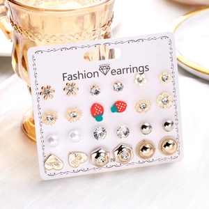Close-up of 12 pairs stud earrings set featuring flowers and hearts on display card