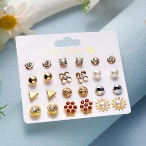 Detail of 12-pair gold earring set with pearls and rhinestones on Love You card display