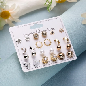 Macro shot of a 9-pair mixed earring set including pearls and rhinestones on card