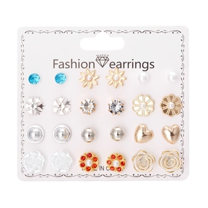 Close-up of 12 pairs of fashion earrings with pearls and crystals on a card