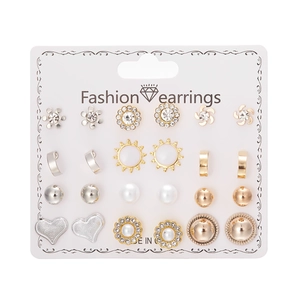 Close-up of 12 pairs of fashion earrings including pearls, rhinestones and flower designs