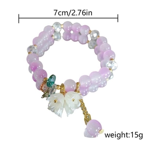 Detail of sweet beaded flower bracelet featuring lily of the valley and purple crystals
