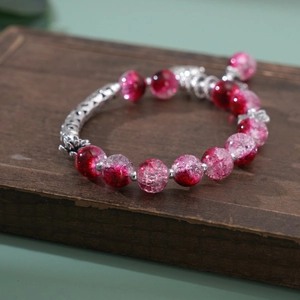 Detailed macro of vintage gradient crackle beads with silver patterned metal spacers