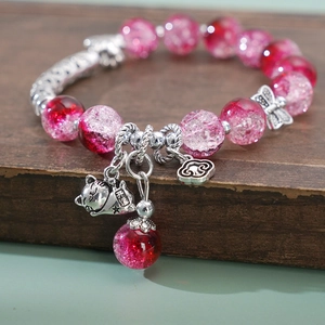Detail of pink crystal bead bracelet with silver Maneki Neko and lucky cloud charms