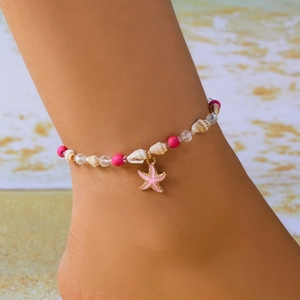 Detailed shot of shell anklet with pink starfish charm on beach holiday scenery