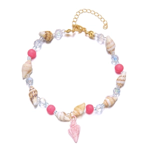 Detail of seashell anklet with pink beads and transparent crystals on white background
