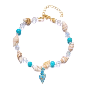 Detailed macro view of conch shell and turquoise beads with a blue metal pendant anklet