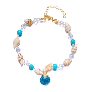 Close-up of seashell and turquoise bead anklet with a blue enamel scallop charm