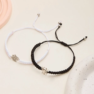 Détail de bracelets tressés avec araignée et toile pour couples, réglables