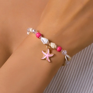 Detailed shot of bohemian beach bracelet with shell charms and pink starfish pendant