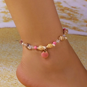Summer beach anklet featuring sea shells and pink beads on a sandy background