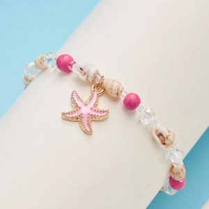 Close-up of beach shell bracelet featuring pink enamel starfish and crystal beads