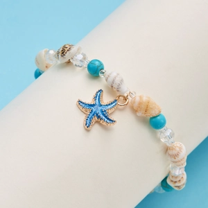 Detailed macro view of sea shell bead bracelet with blue starfish pendant charm