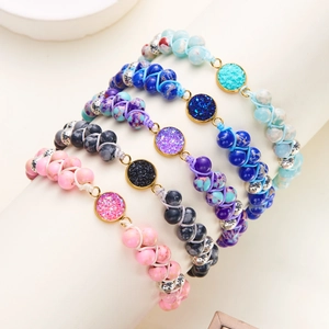 Cinco pulseras bohemias artesanales de cuentas y piedras naturales en un soporte de joyas